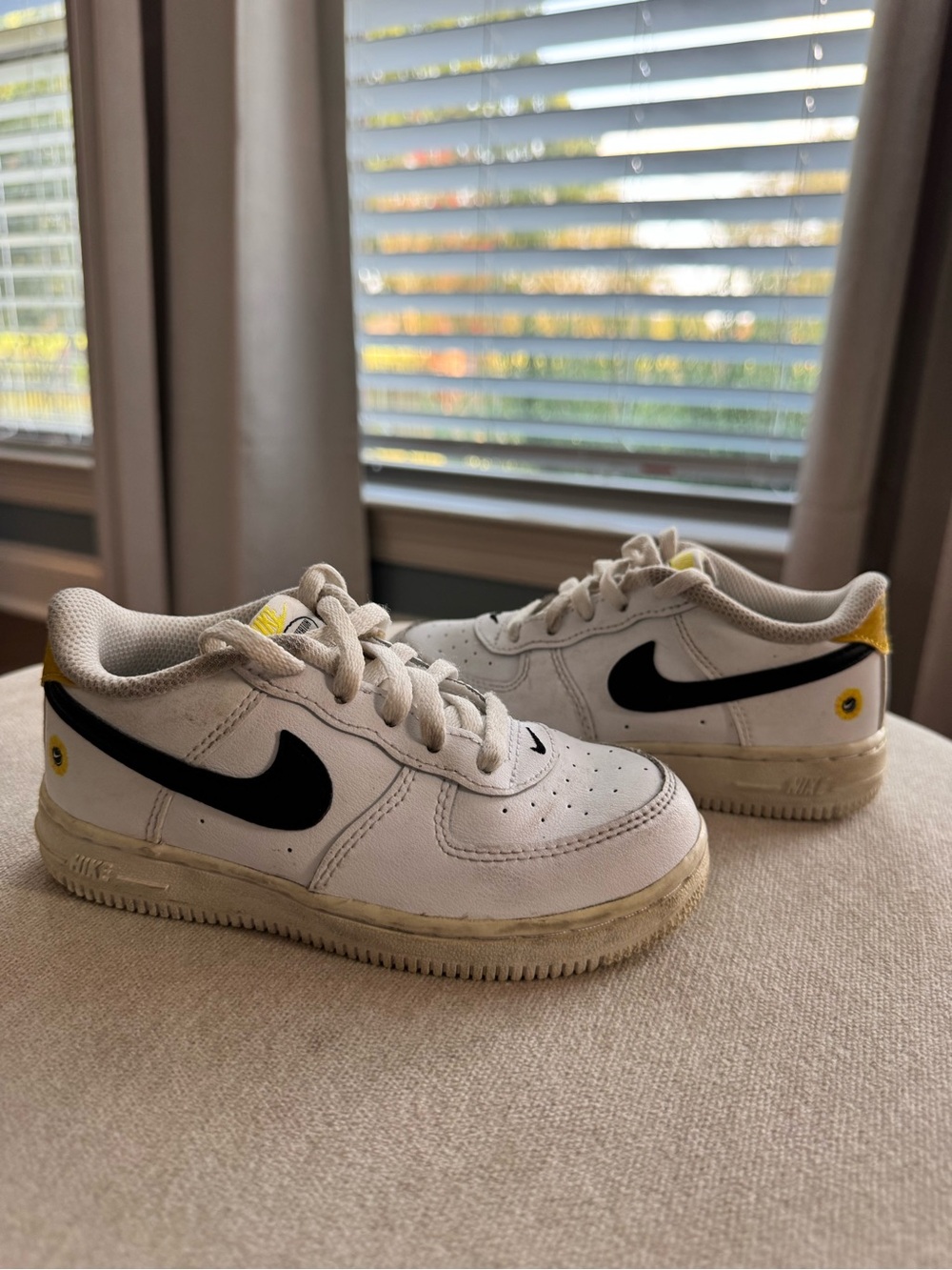 Nike Kids White Sneakers with Black Swoosh and Yellow Accents